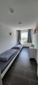a room with two beds and a window at Gästewohnung KL. WZL 29_7 in Klein Wanzleben