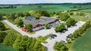 an aerial view of a large red barn with a parking lot at Vilcon Hotel & Konferencegaard in Slagelse