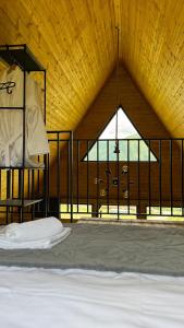a room with a bed with a large window at Lunara Chalet in Kazbegi