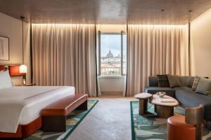 a hotel room with a bed and a couch at Thompson Rome, By Hyatt in Rome