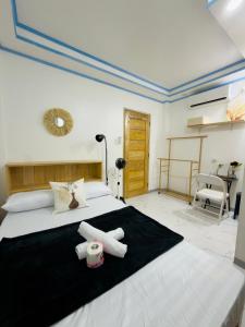 a bedroom with a bed with two white towels on it at Beachside Room with Bathroom San Juan ELYU in San Juan