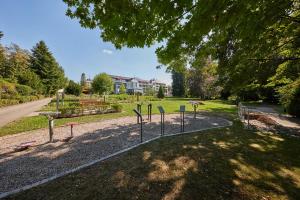 a park with signs on the side of a road at Kneippkurhaus St Josef in Bad Wörishofen