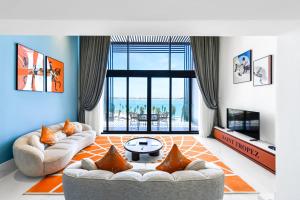 a living room with two couches and a large window at M Hotels at Porto Marina in El Alamein