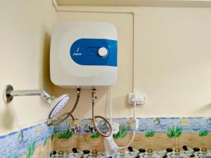 a soap dispenser on a bathroom wall with rocks at Tenzin Homestay in Dirang Dzong
