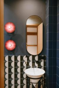 a bathroom with a sink and a mirror at Meidan Heritage Suites Tbilisi in Tbilisi City