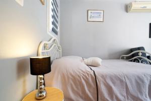 a bedroom with a bed with a lamp on a table at Studio Montayral in Montayral +26 photos