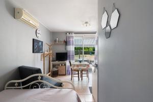 a bedroom with a bed and a dining room with a table at Studio Montayral in Montayral