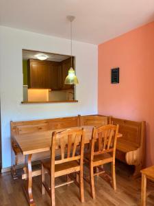 a dining room with a wooden table and chairs at Ambiente de montaña- Chimenea, vistas y jardín- Isard 4 in Pla de l'Ermita +33 photos