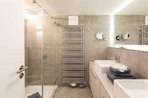 a bathroom with a shower and a sink and a mirror at Wohnung 14 Am Januspark in Juist +29 photos