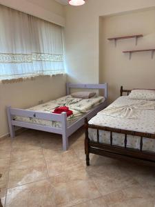 two twin beds in a room with at Garbo Appartments in Karistos