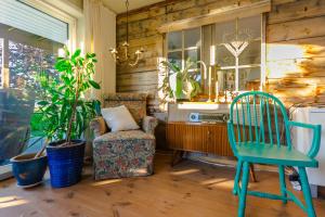 a living room with a chair and a desk and a chair at Strandheimen Guesthouse in Melhus