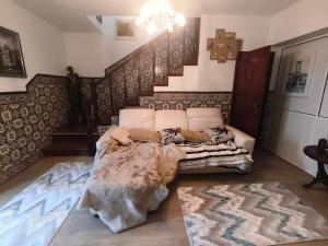 a bed sitting in a room with a staircase at Orion Guest Villa Casais in Lousada +173 photos