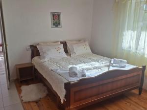 a bedroom with a bed with shoes on it at Gardenhouse in Mëmëlisht