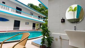 a bathroom with a mirror and a swimming pool at The Mint Calangute in Calangute