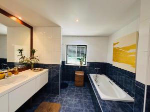 a bathroom with two sinks and a bath tub at The Yellow Retreat in A dos Cunhados +117 photos