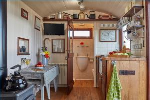 a small kitchen with a sink and a table at Lens Hut in Masbury Station