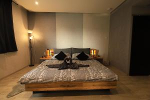 a bedroom with a bed with a stuffed animal on it at Apartmán Elarys in Nezdenice
