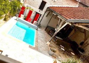 an overhead view of a swimming pool next to a house at Gite de Bourgogne in Sainte-Marie-sur-Ouche