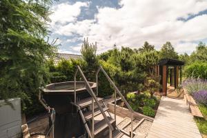 a garden with a wooden boardwalk and a playground at Osada Marchowo in Kielno