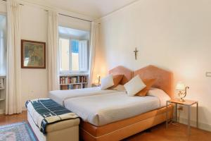 a bedroom with a bed with a cross on the wall at Villa Pian dei Giullari con Piscina in Florence +27 photos