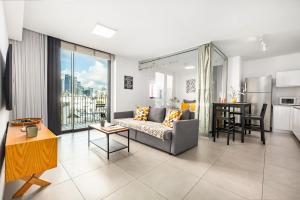 a living room with a couch and a table at Mr Elifelet View with a Pool Neve Tsedek in Mashabbe Sade