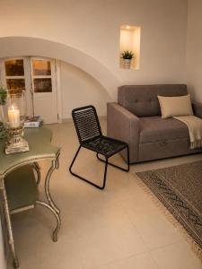a living room with a couch and a chair at Ductus Aquae House in Évora