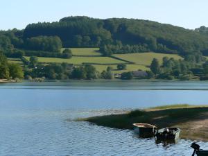 two boats sitting on the shore of a lake at Gîte la Roche du Gravillot in Château-Chinon