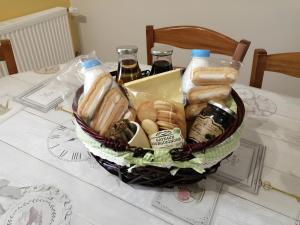 a basket of bread and drinks on a table at Gîte la Roche du Gravillot in Château-Chinon