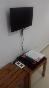 a computer monitor and a keyboard on a wooden table at Mogan Valle Cercado in Mogán