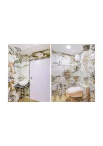 a bathroom with a toilet and a wall at Hotel Prime 24 in Ahmedabad +47 photos