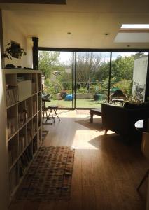 a living room with a large window and a couch at Chambre ville & campagne in Nantes
