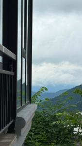 a window with a view of a mountain view at Panorama Cottages Tbeti in Shuakhevi