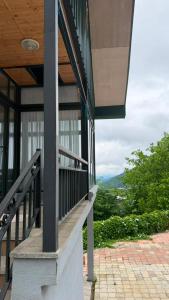 a balcony of a building with a view of the mountains at Panorama Cottages Tbeti in Shuakhevi