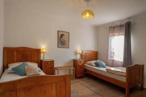 a bedroom with two beds and a window at Holiday House Rea with BBQ and two terrace in Sveti Donat