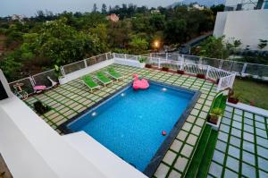 an overhead view of a swimming pool on a house at EKOSTAY Luxe - Noah Villa with Peddle Court & Sunset View in Lonavala