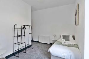 a bedroom with a bed with swans on it at Contractor-Friendly - Hawick - Free Parking - 2BR in Hawick