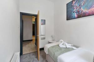 a bedroom with a bed and a picture of a deer on the wall at Contractor-Friendly - Hawick - Free Parking - 2BR in Hawick +3 photos