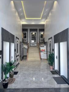a lobby with a staircase and some plants at Japandi vibe new apartment in Riyadh