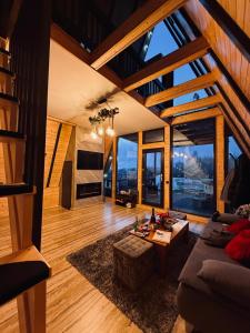 a living room with a couch and a table at Cabana Ross-A in Poenari