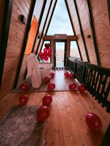a room with red balloons on a wooden floor at Cabana Ross-A in Poenari +52 photos