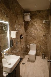 a bathroom with a sink and a toilet at The Park Central in Lucknow +27 photos