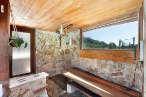 a stone room with a bench and a window at Villa Aresini - Dimora Esclusiva in Montemiletto +33 photos