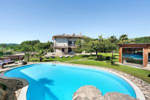 a large blue swimming pool in front of a house at Villa Aresini - Dimora Esclusiva in Montemiletto