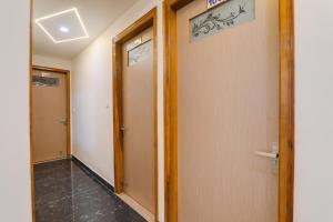 a hallway with two elevators in a building at Hotel O Happy Times Vishveshwar Park in Gomti Nagar