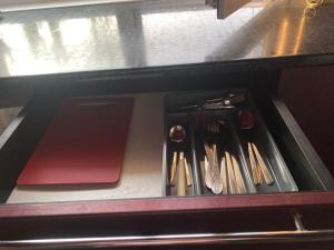 a drawer filled with utensils in a drawerasteryasteryasteryasteryasteryastery at Forest Edge house in Kolonshchina