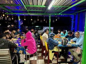 a group of people sitting at tables in a restaurant at Tenzin Homestay in Dirang Dzong +54 photos