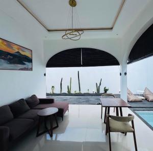 a living room with a couch and a table at Kama villa in Uluwatu