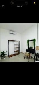 a living room with a table and a mirror at Kama villa in Uluwatu