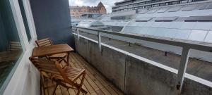 two chairs on a balcony with a view of a building at Ylätori 2A in Vaasa +4 photos