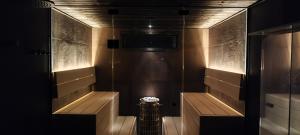 a bathroom with a shower with a television on the wall at Ylätori 2A in Vaasa